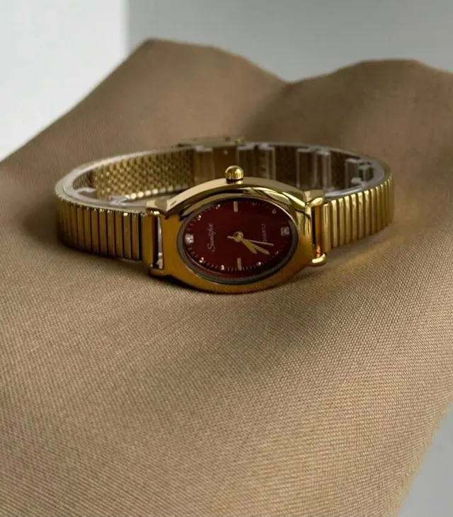 Gold Oval Watch with Garnet Dial